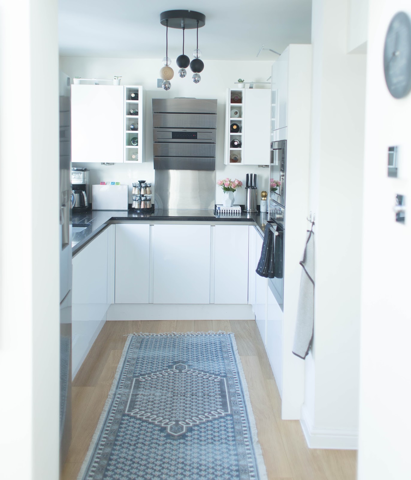 Magnet Integra kitchen with white gloss handless cabinets, quartz worktops and integrated appliances after renovation