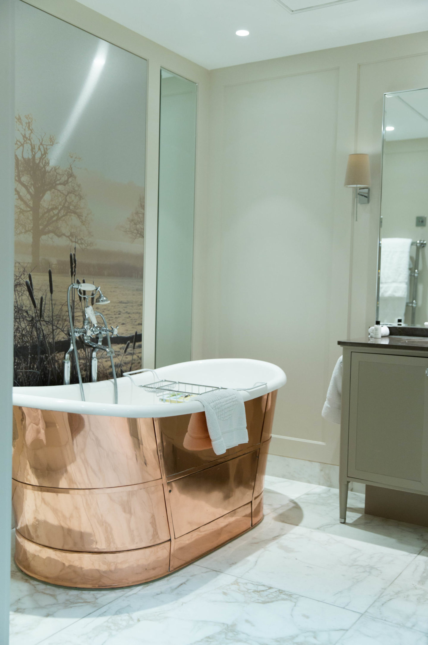 Coworth Park luxury bathroom featuring a statement copper bath