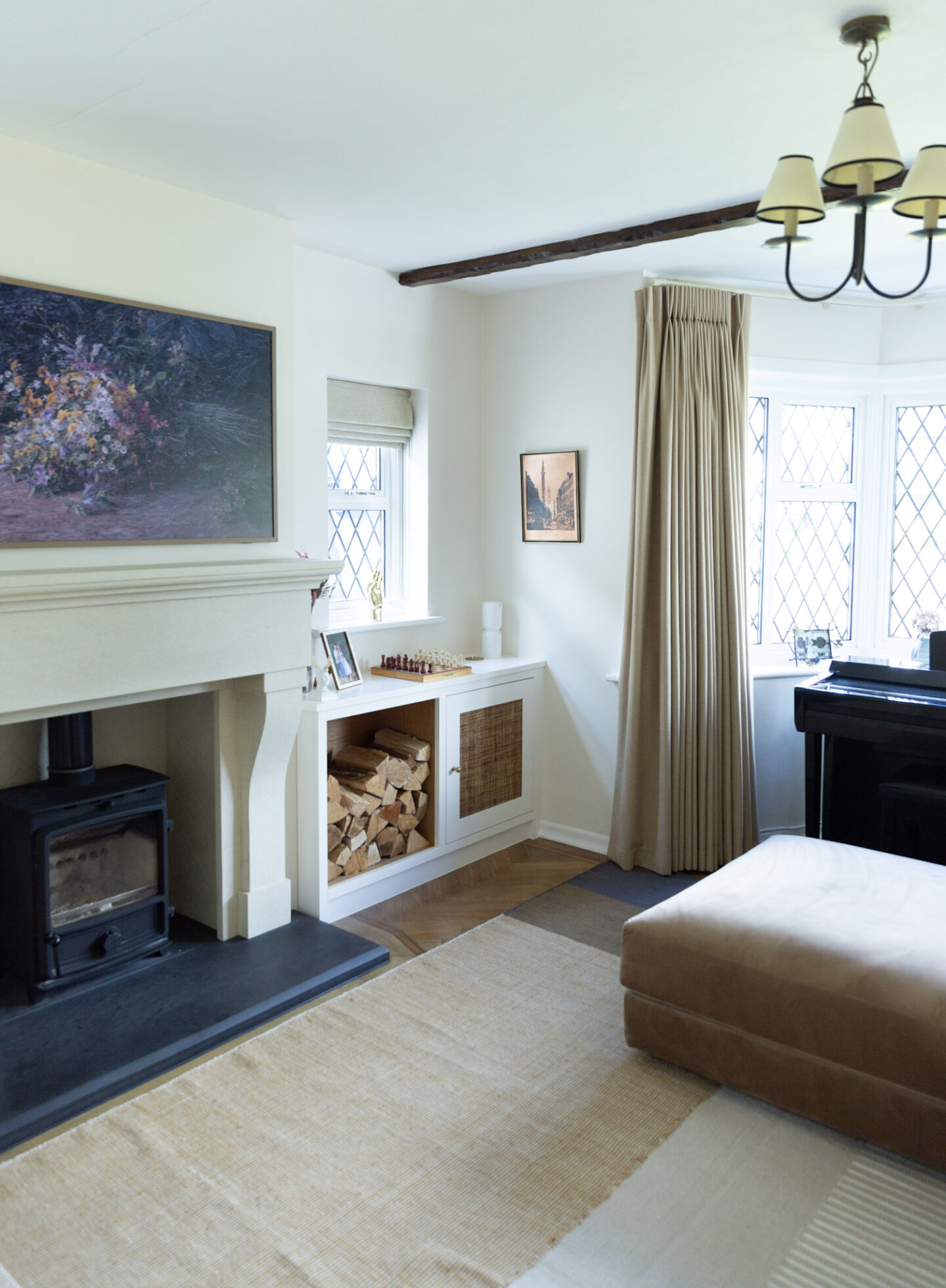 Neutral interior scheme in a living room featuring a French fireplace and alcoves. 