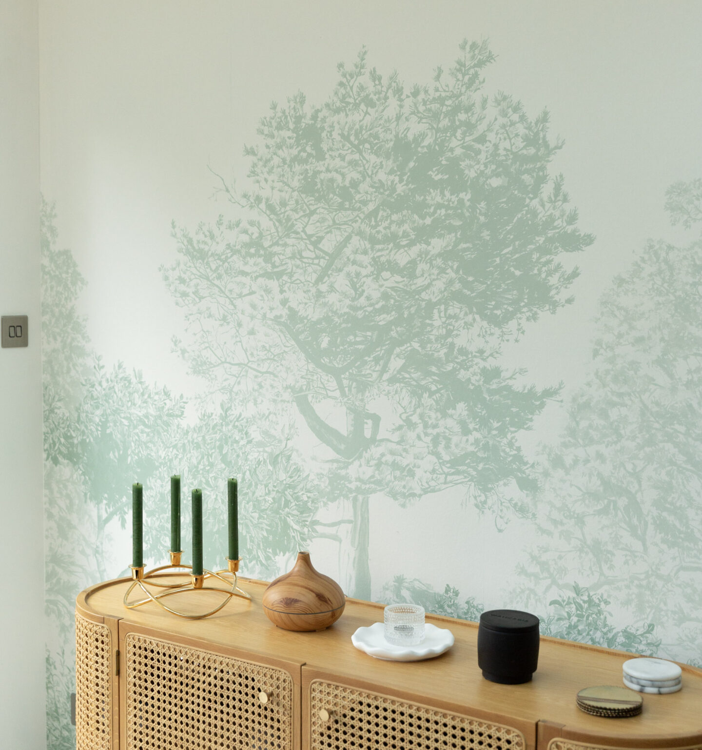 Oak rattan sideboard styled with decorative pieces.