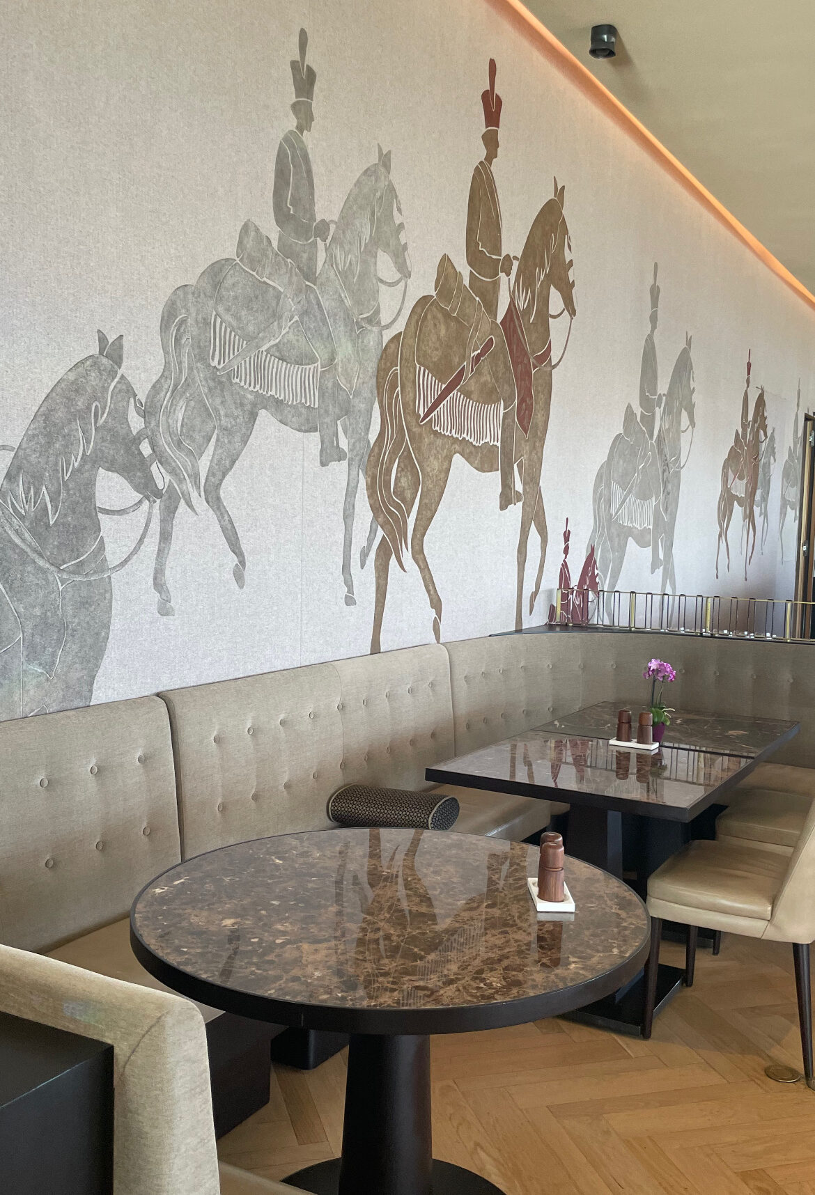 Elegant equestrian-inspired dining room featuring horse-themed wallpaper and a neutral colour palette