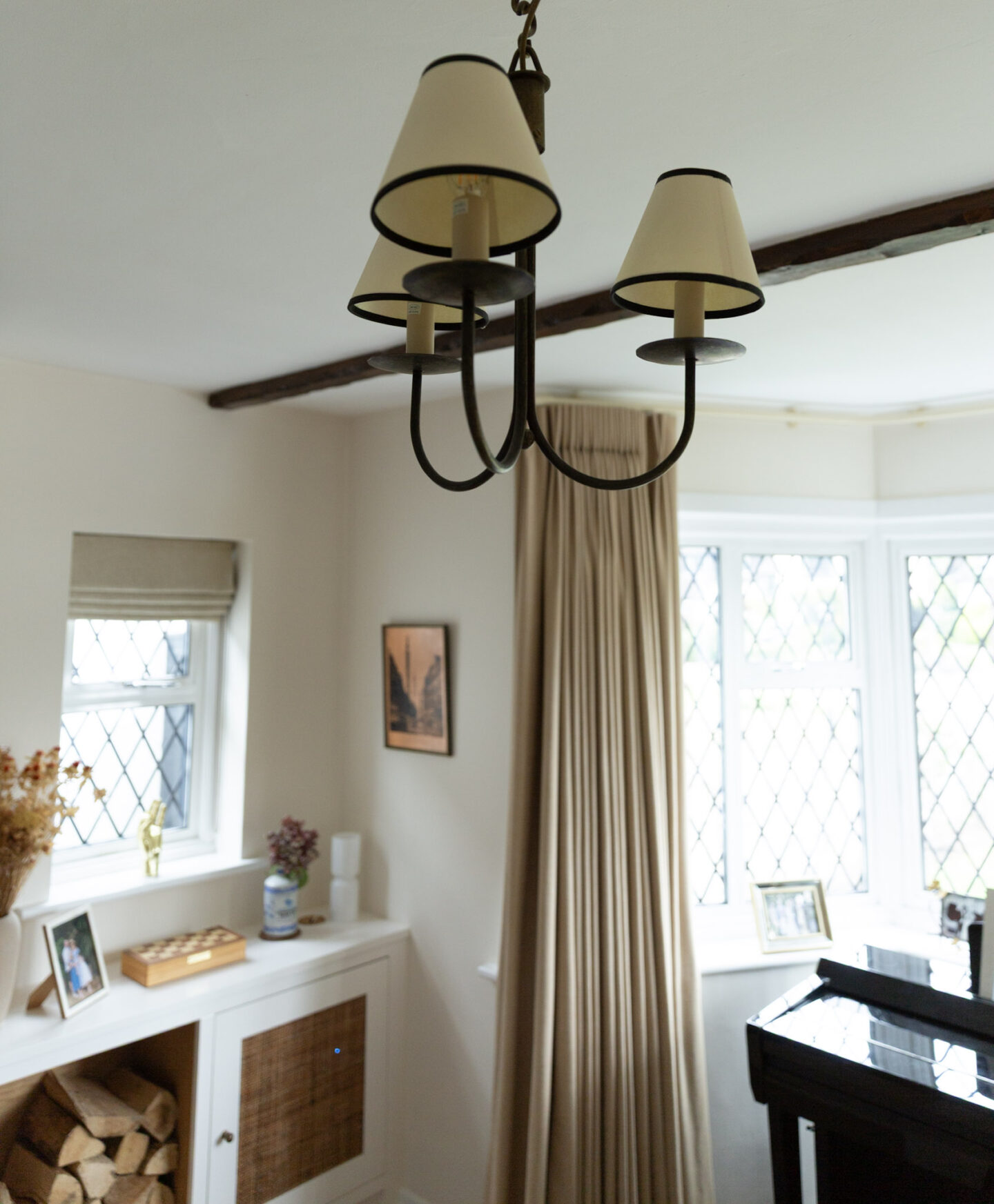 Traditional candle-style chandelier with fabric lamp shades.