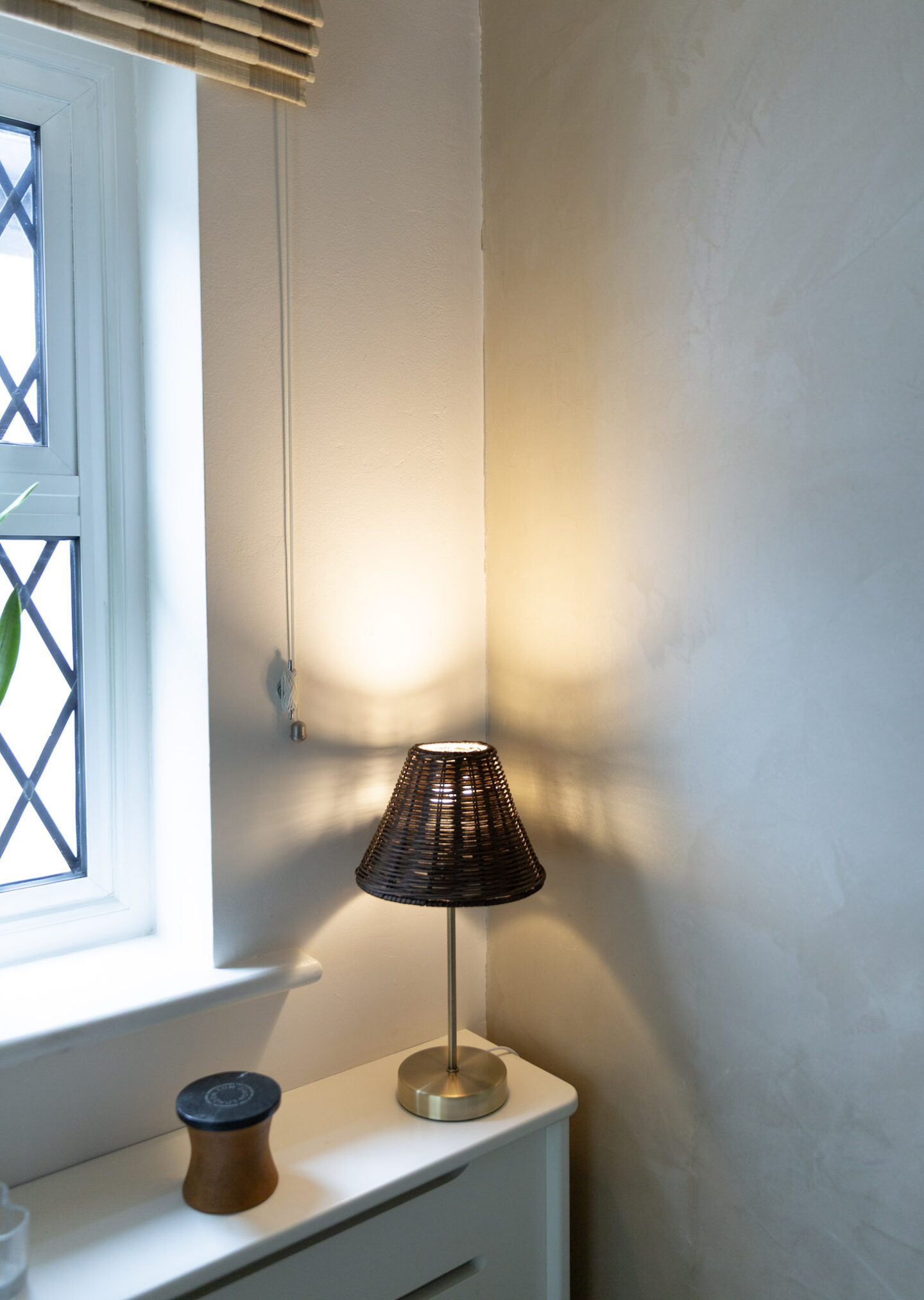 Brown rattan table lamp with a gold base for cosy autumn nights