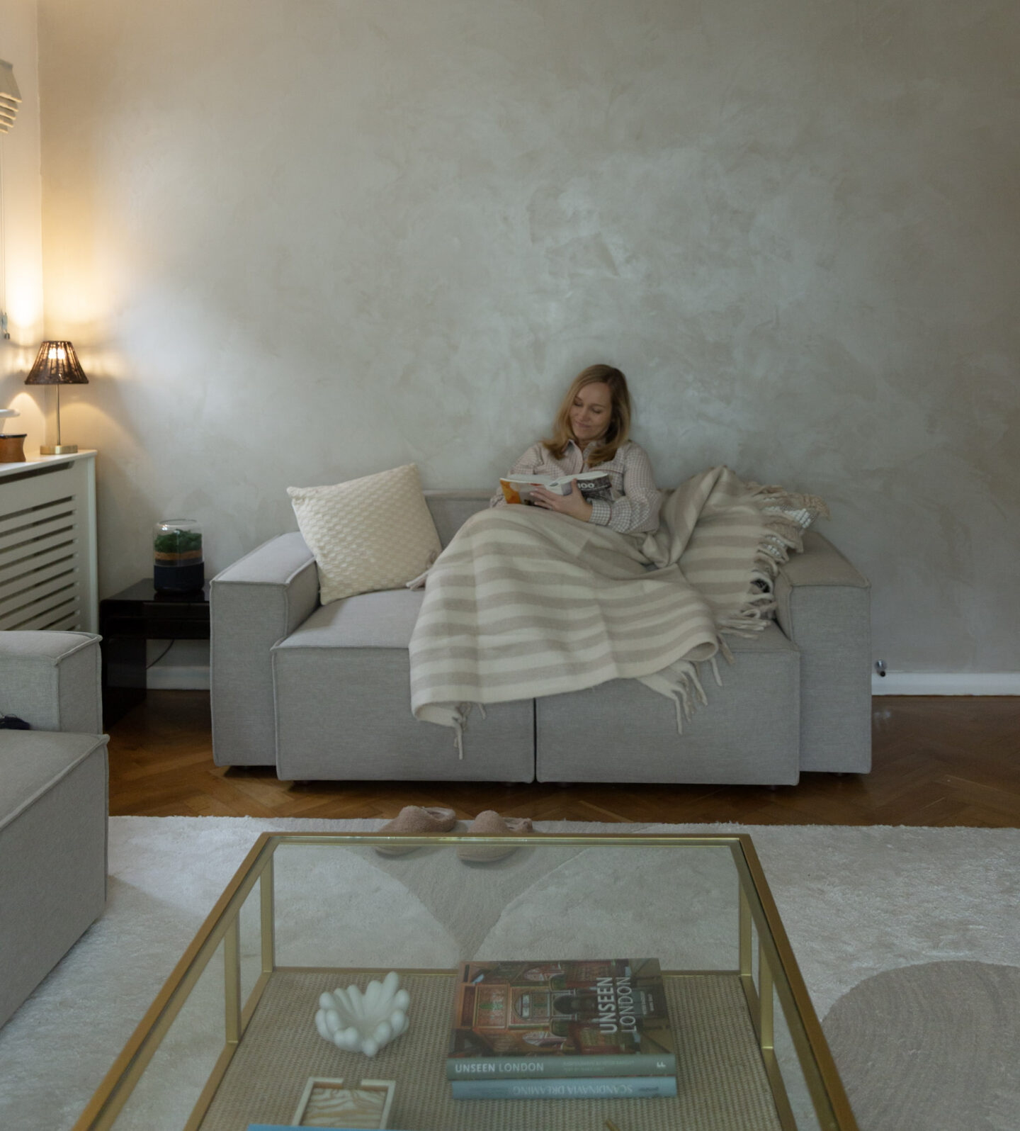 Soft wool throw and woven cushions in neutral tones for cosy autumn living room
