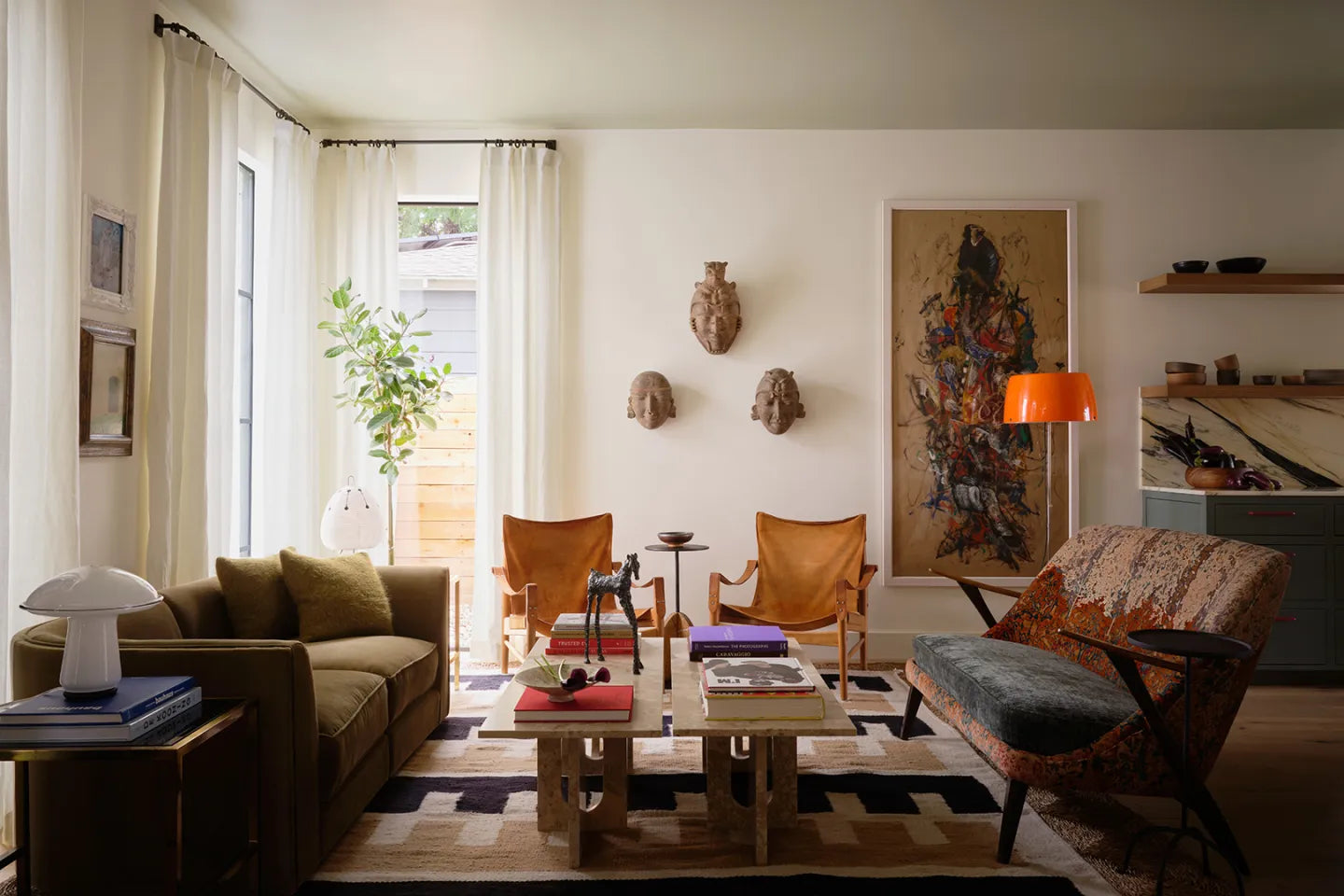 Eclectic living room design with vintage sofas and modern area rug and quirky wall art.