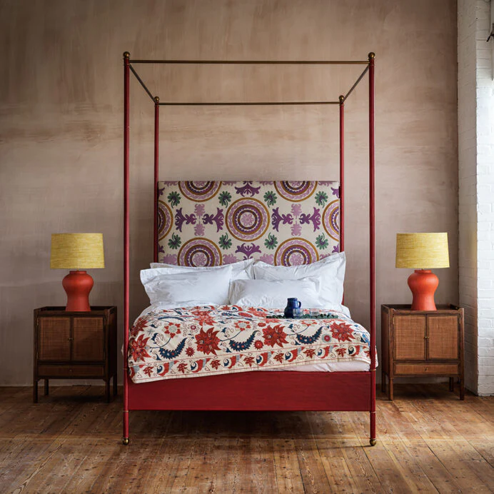 Red four-poster bed, midcentury modern style.