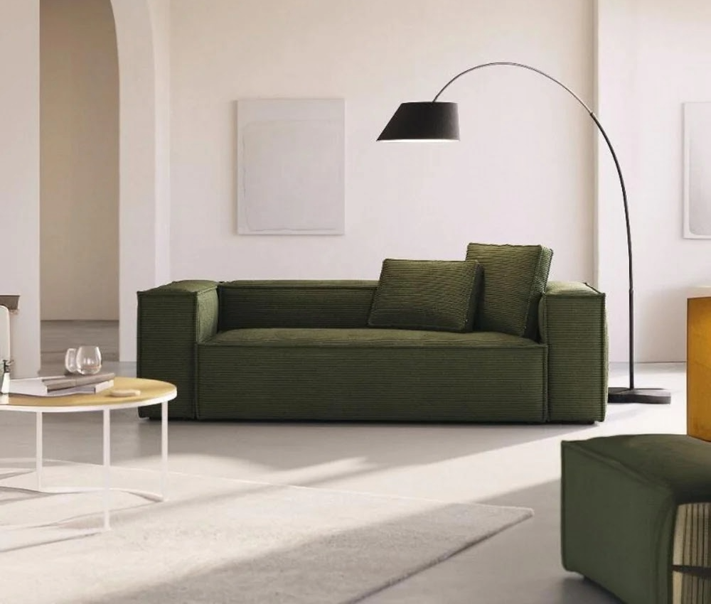 Green minimalist 4-seater sofa in a contemporary living room with modern furniture.