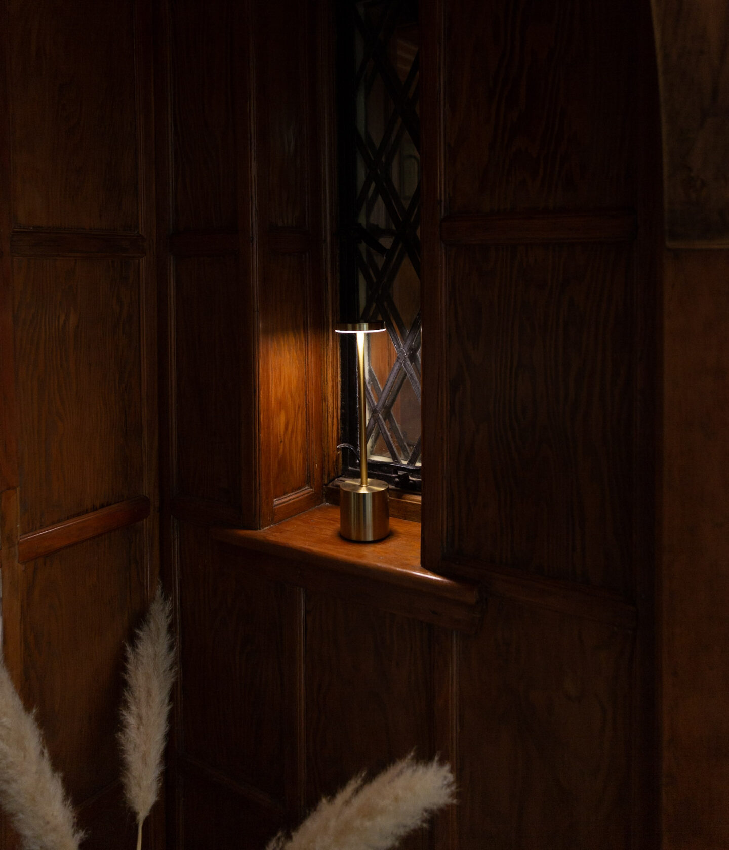 Gold Portable Table Lamp In a Dark Corner