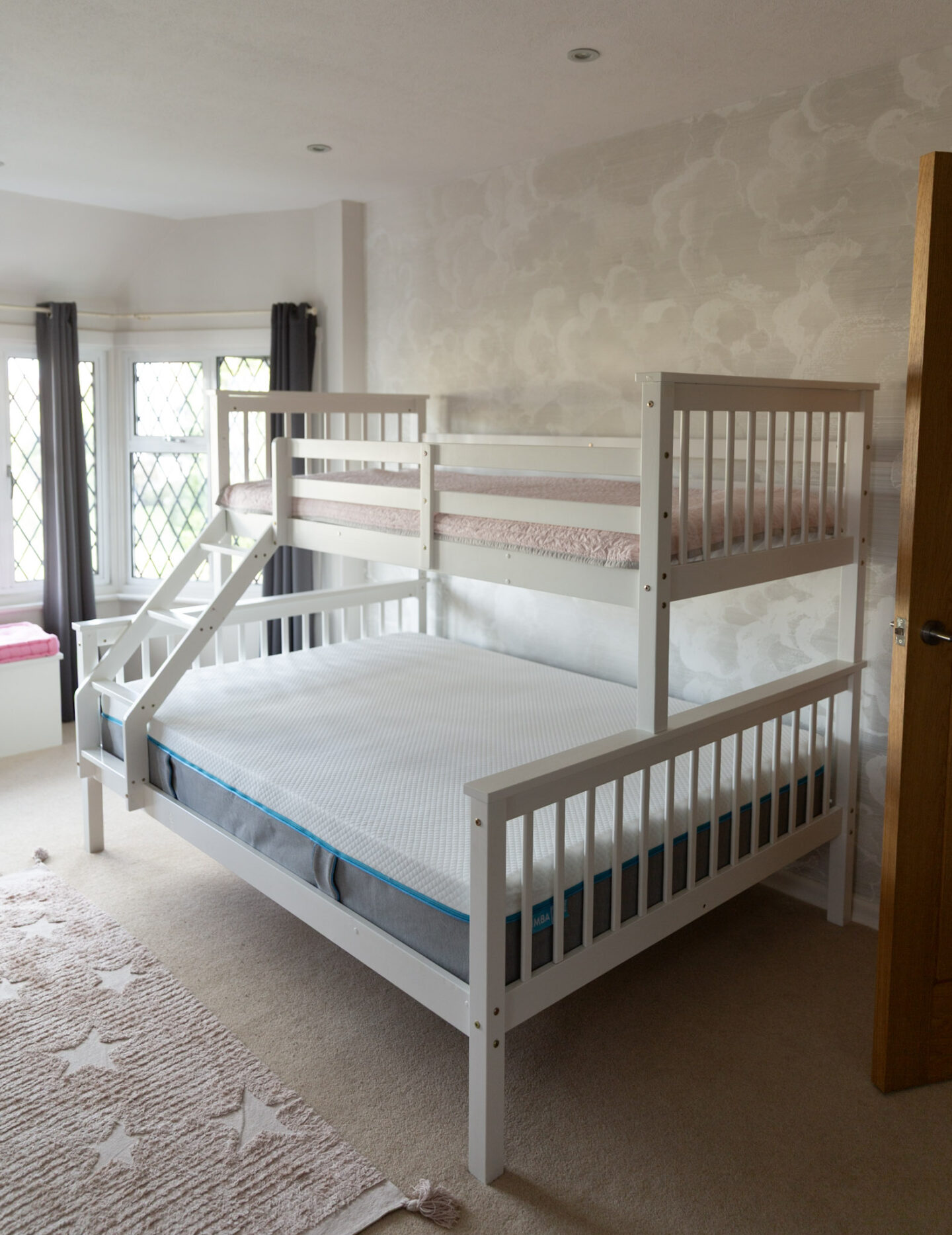 Bunk bed with a Simba Hybrid mattress fitted on the bottom bunk, shown in a bright bedroom.