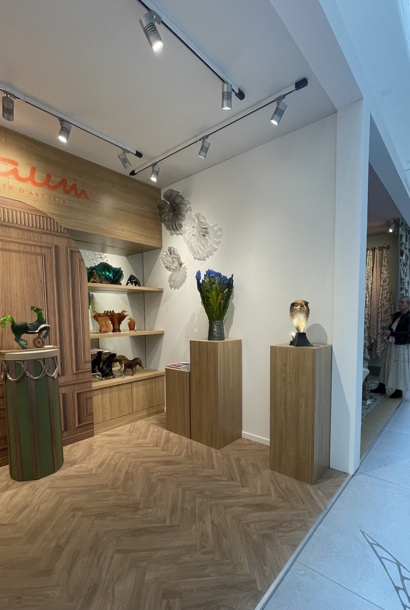 Wooden plinths at a design event featuring flowers on top.