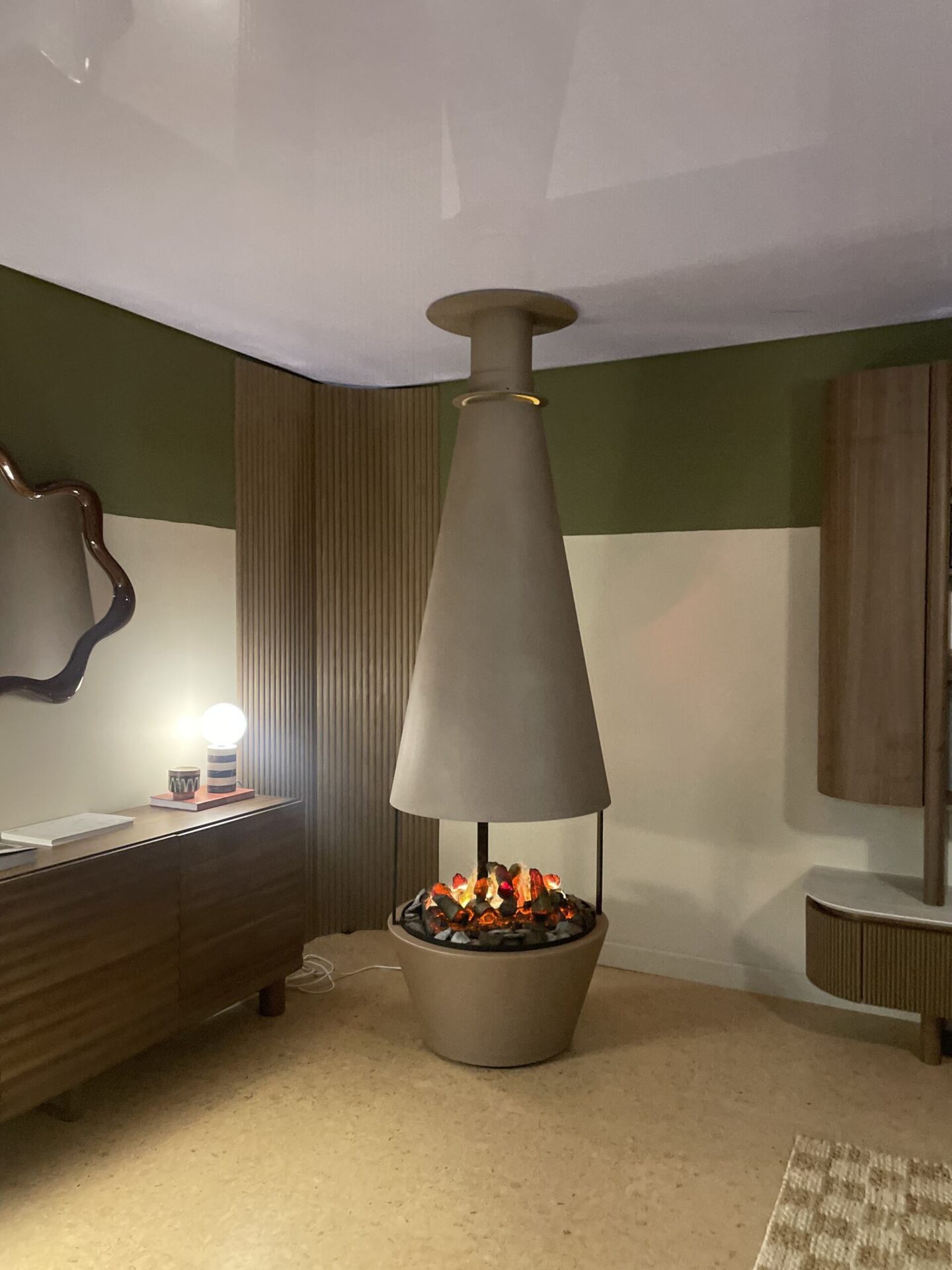 Sero Clean Fuel Fireplace in a living room with modern wood slatted panelling and muted colours.