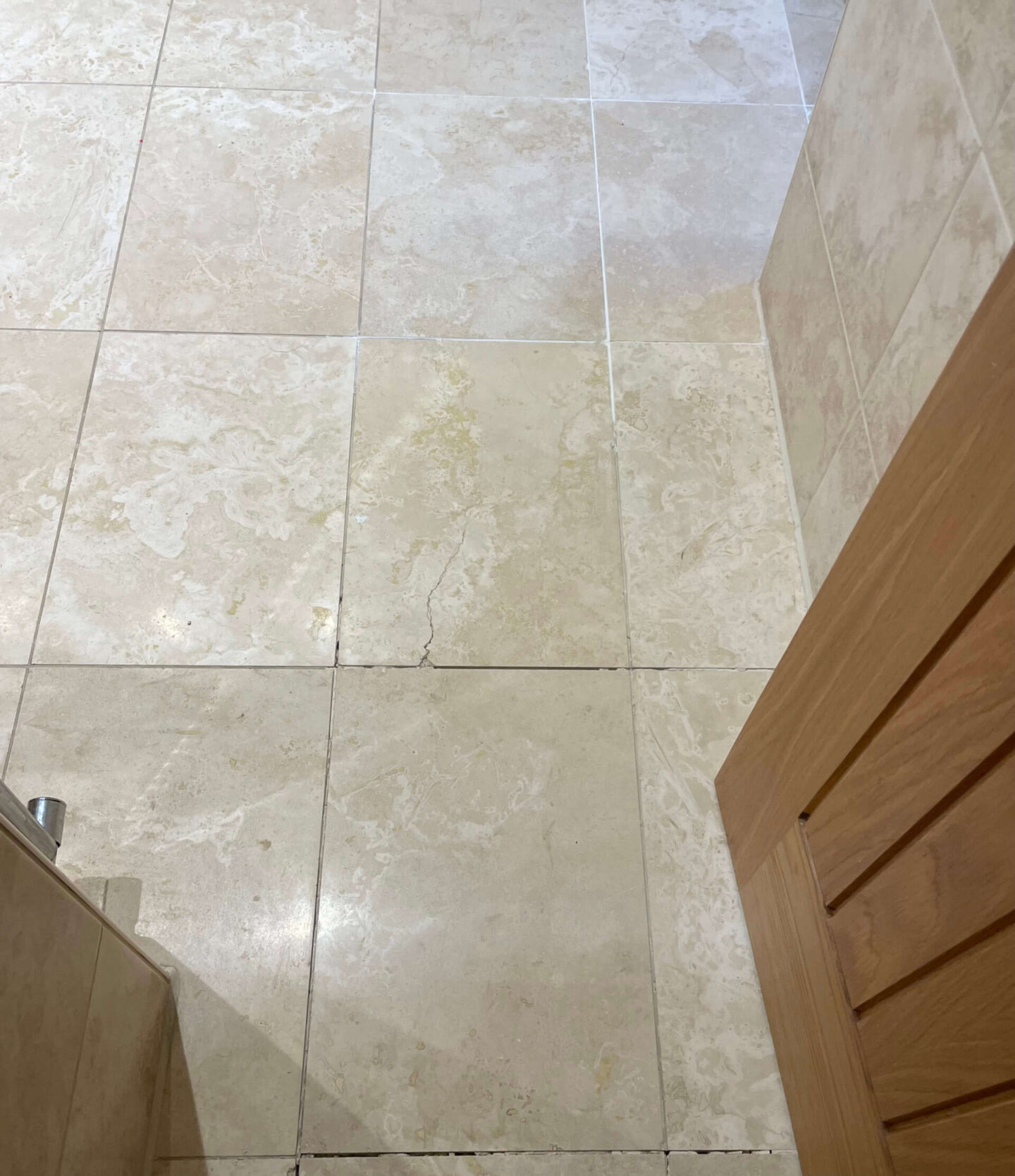 Repairing cracks on travertine floor tiles