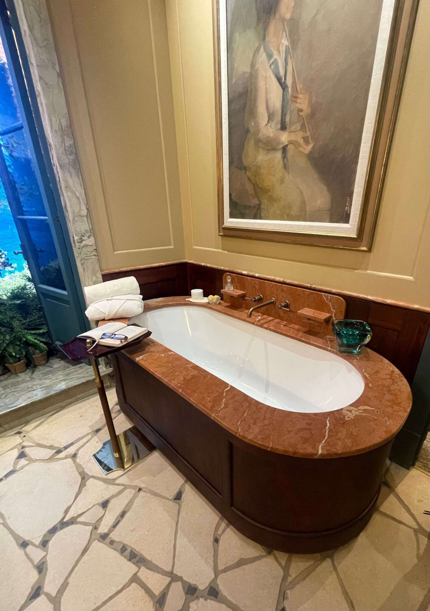 Luxury bathroom design featuring patterned tiles, artwork and layered details instead of traditional uniform tiling