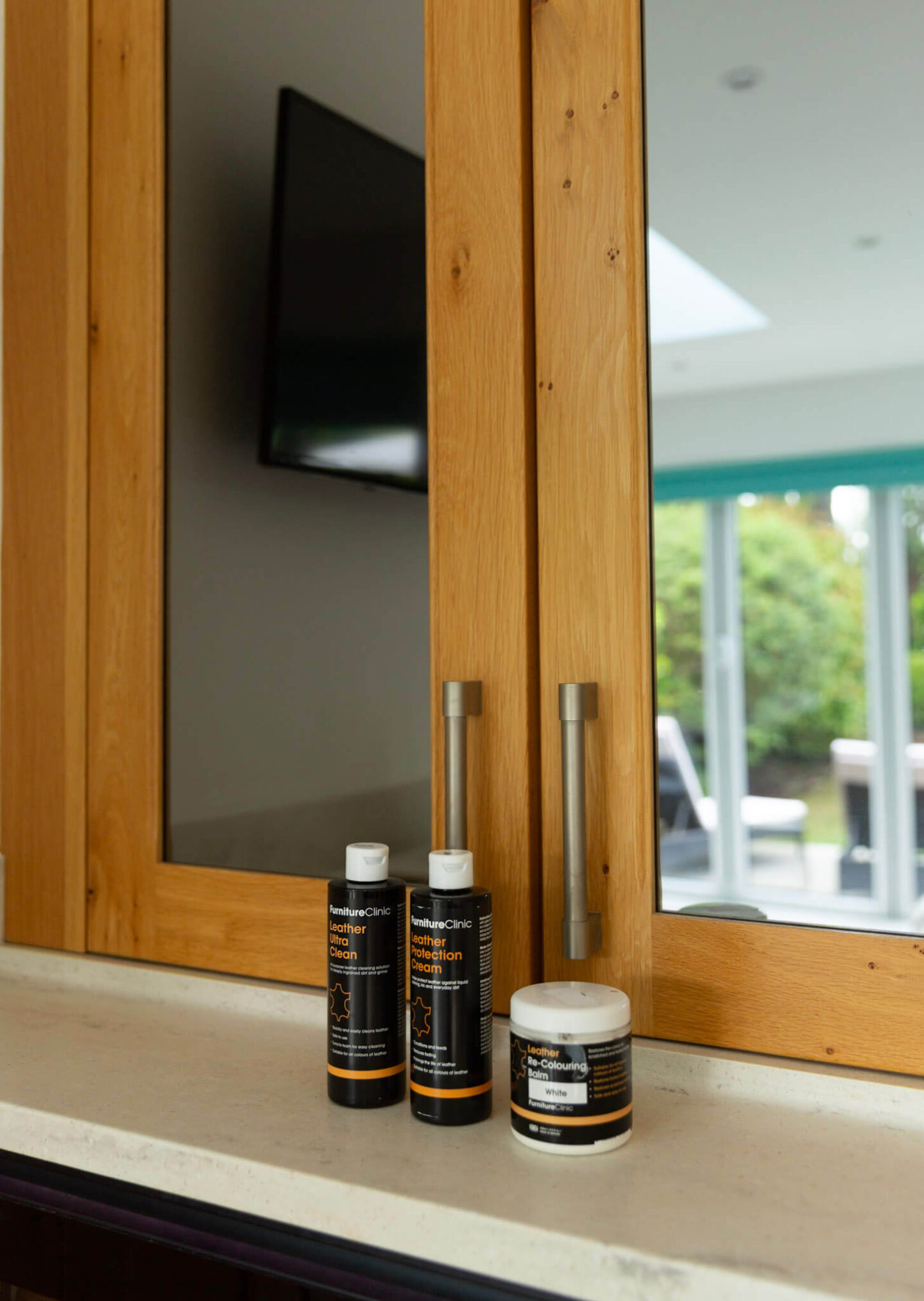 Three Furniture Clinic leather care products used for the bar stool restoration: cleaner, colouring balm and protector.