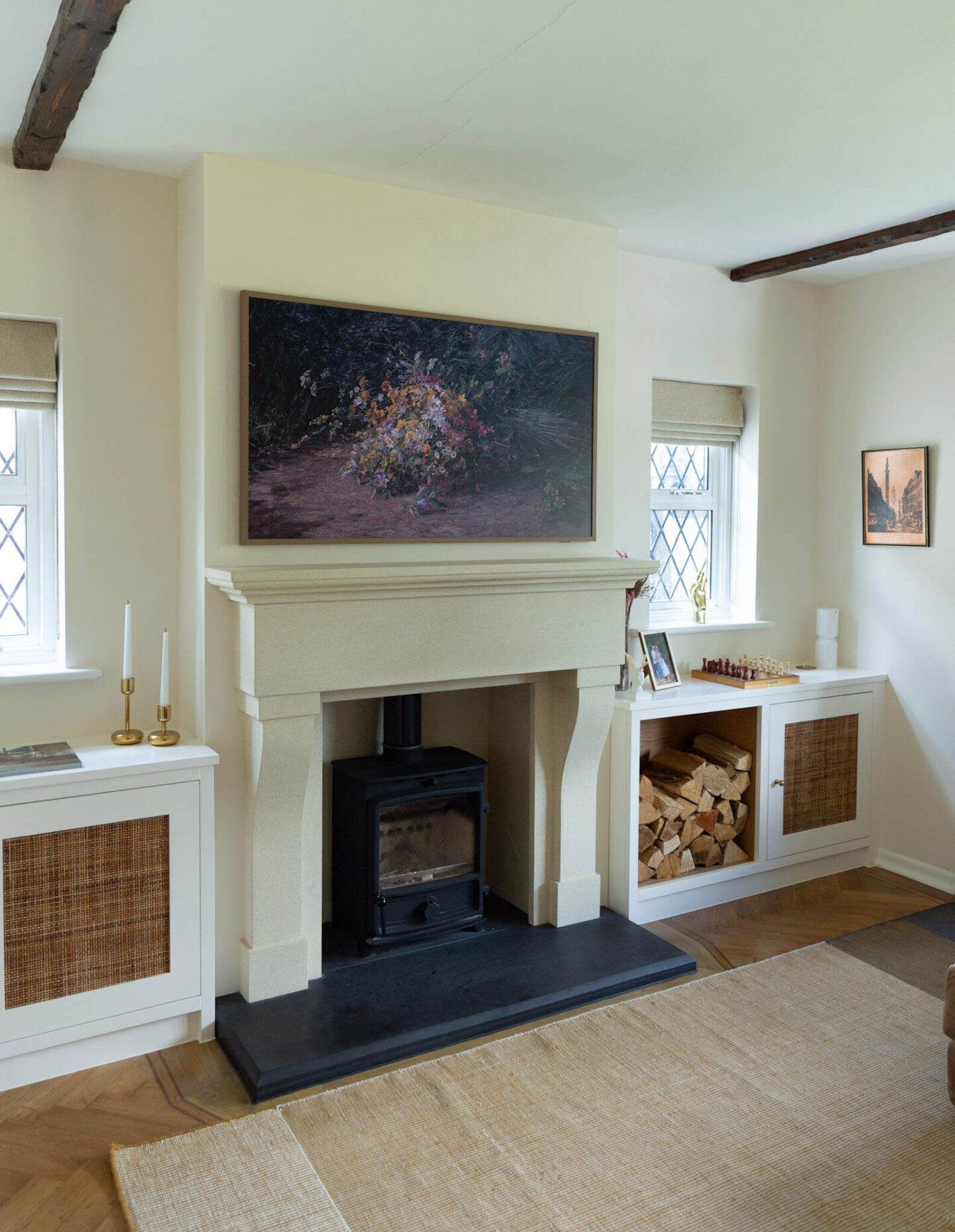 Elegant French-style fireplace mantel and a log burner in a 1920s period home living room