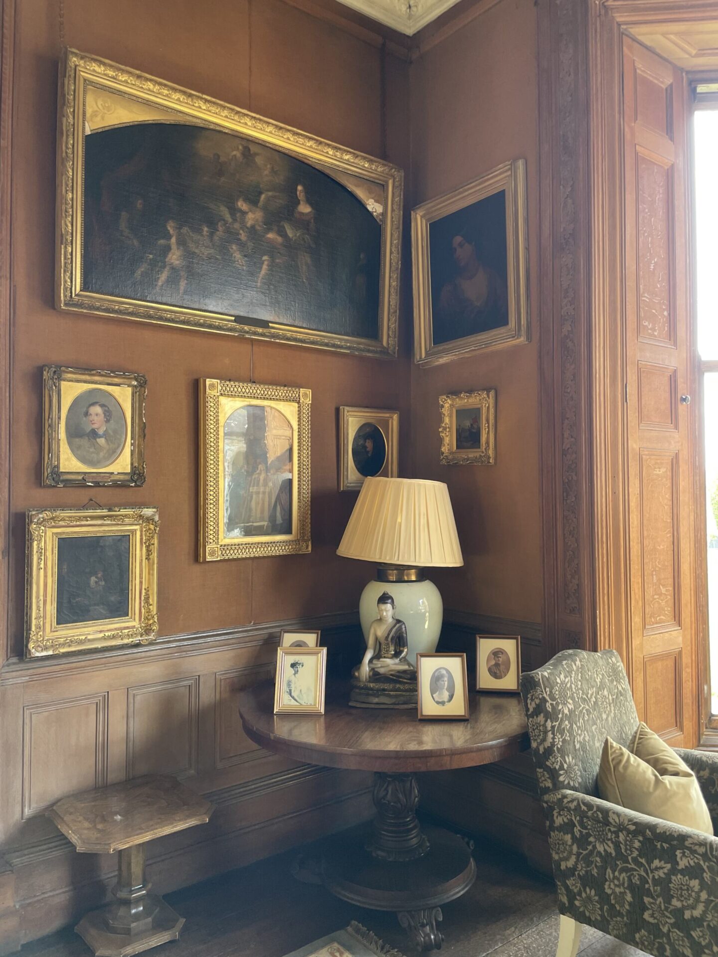 Gallery wall of framed artwork in the Drawing Room at Castle Leslie Estate.