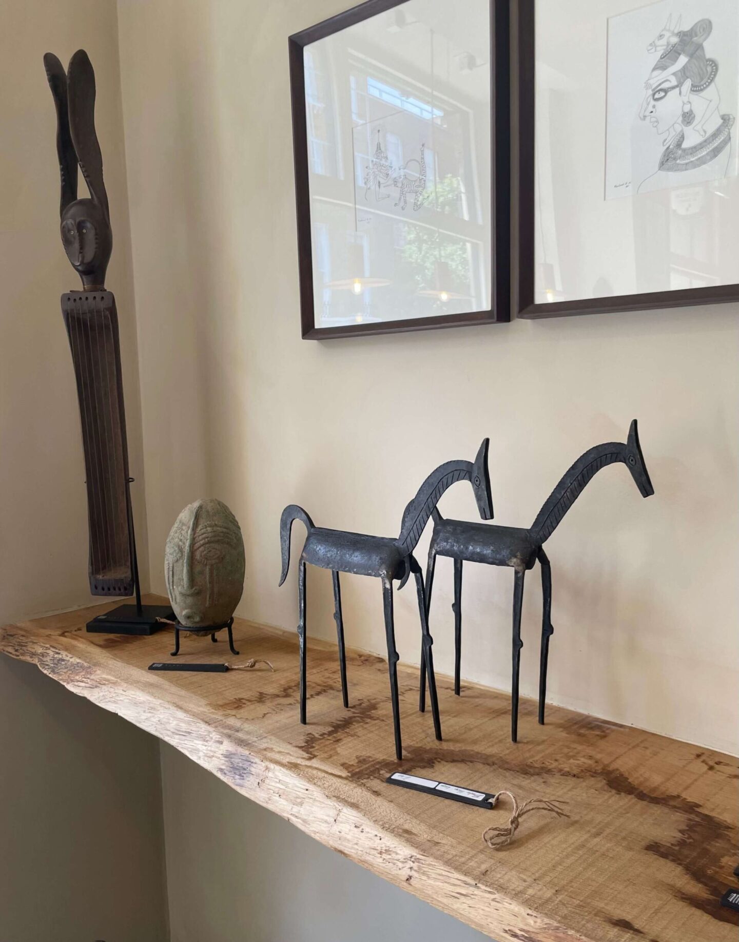 Contemporary iron horse figurines on a wooden shelf
