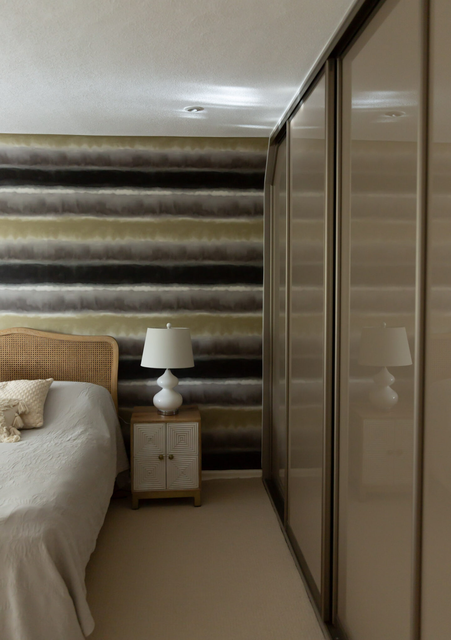 Existing wallpaper feature wall in a period property master bedroom