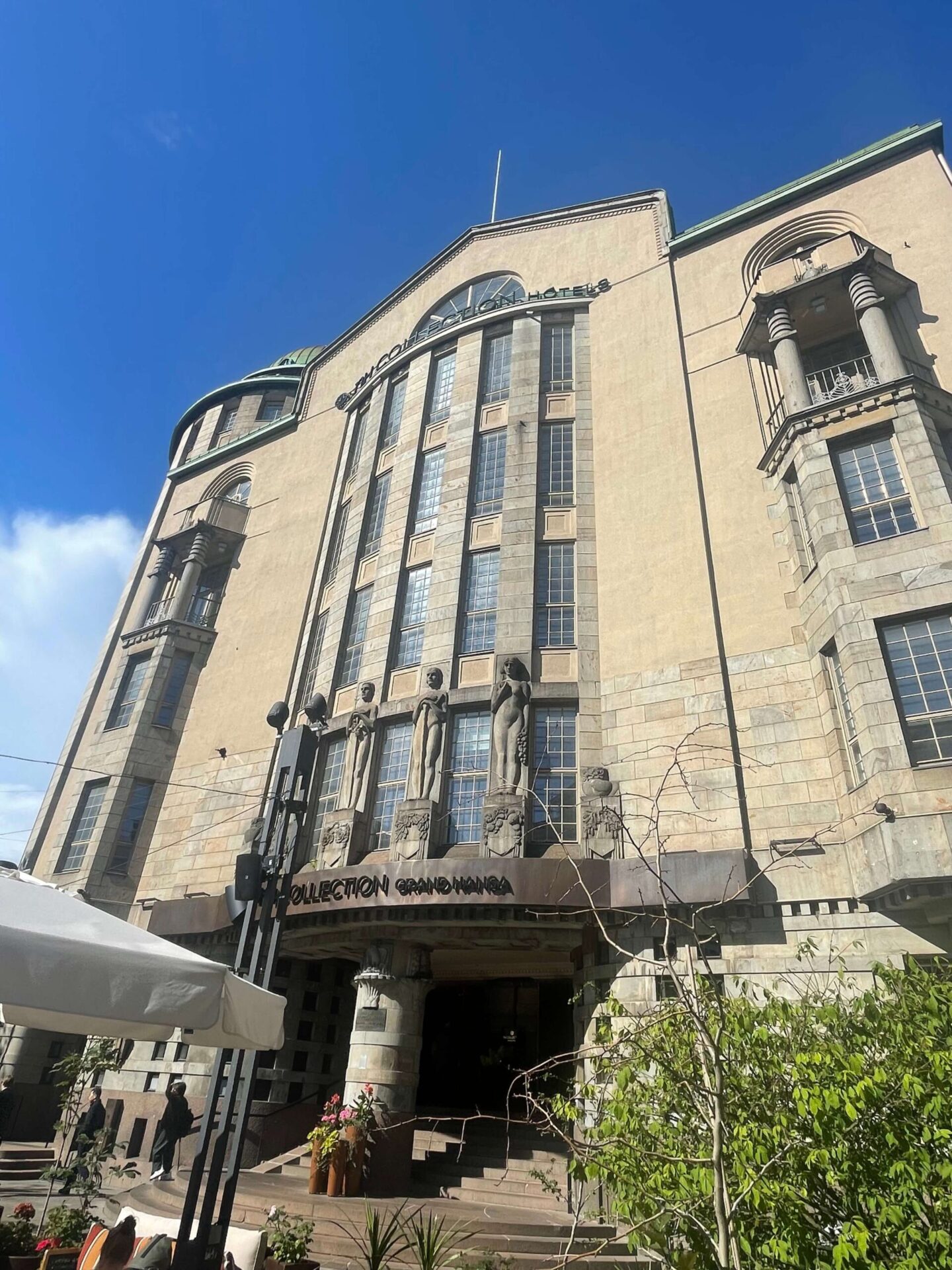 Grand hotel entrance with historic architectural details and columns.