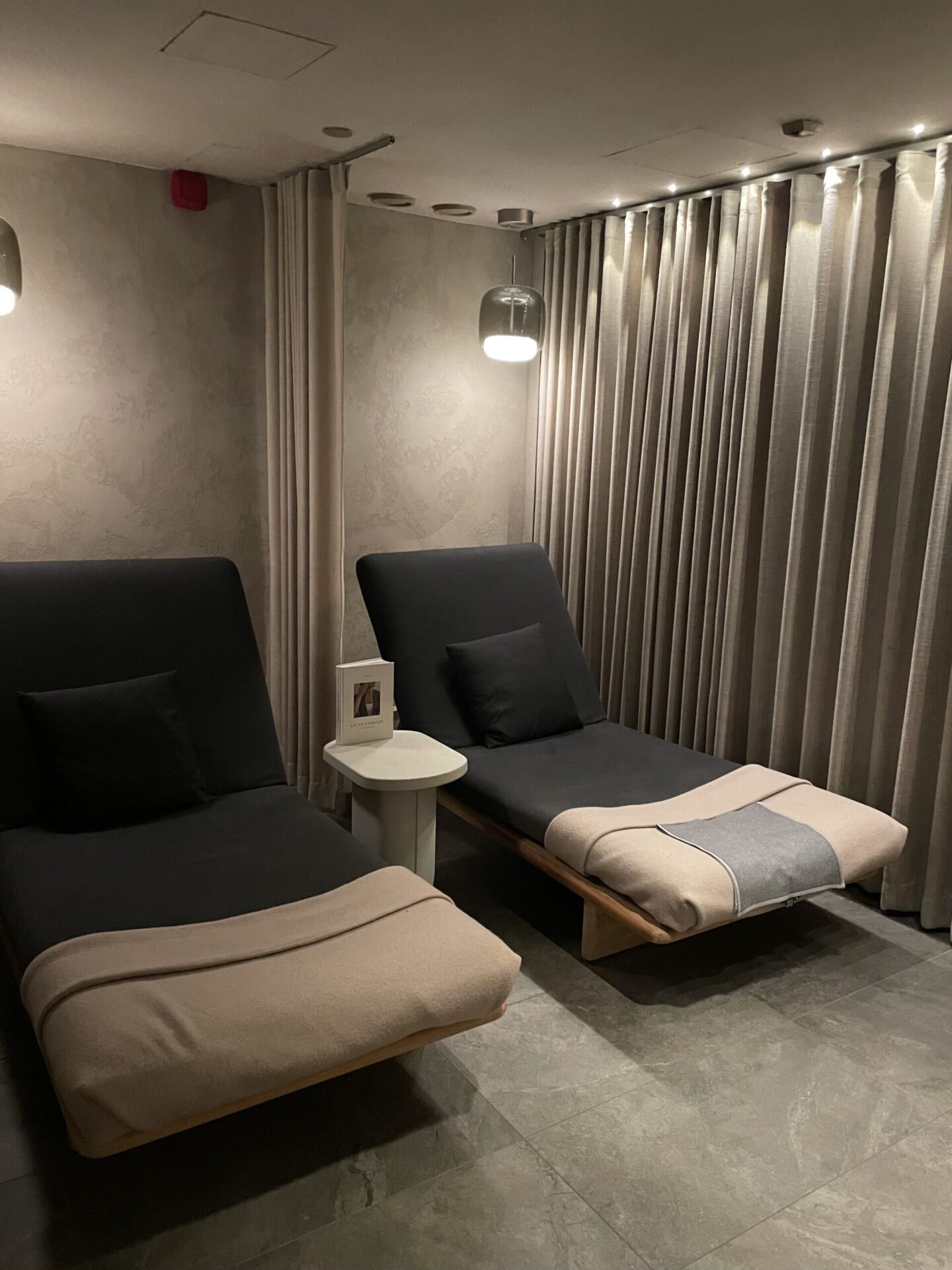 Serene spa relaxation room with comfortable seating and a calming atmosphere.