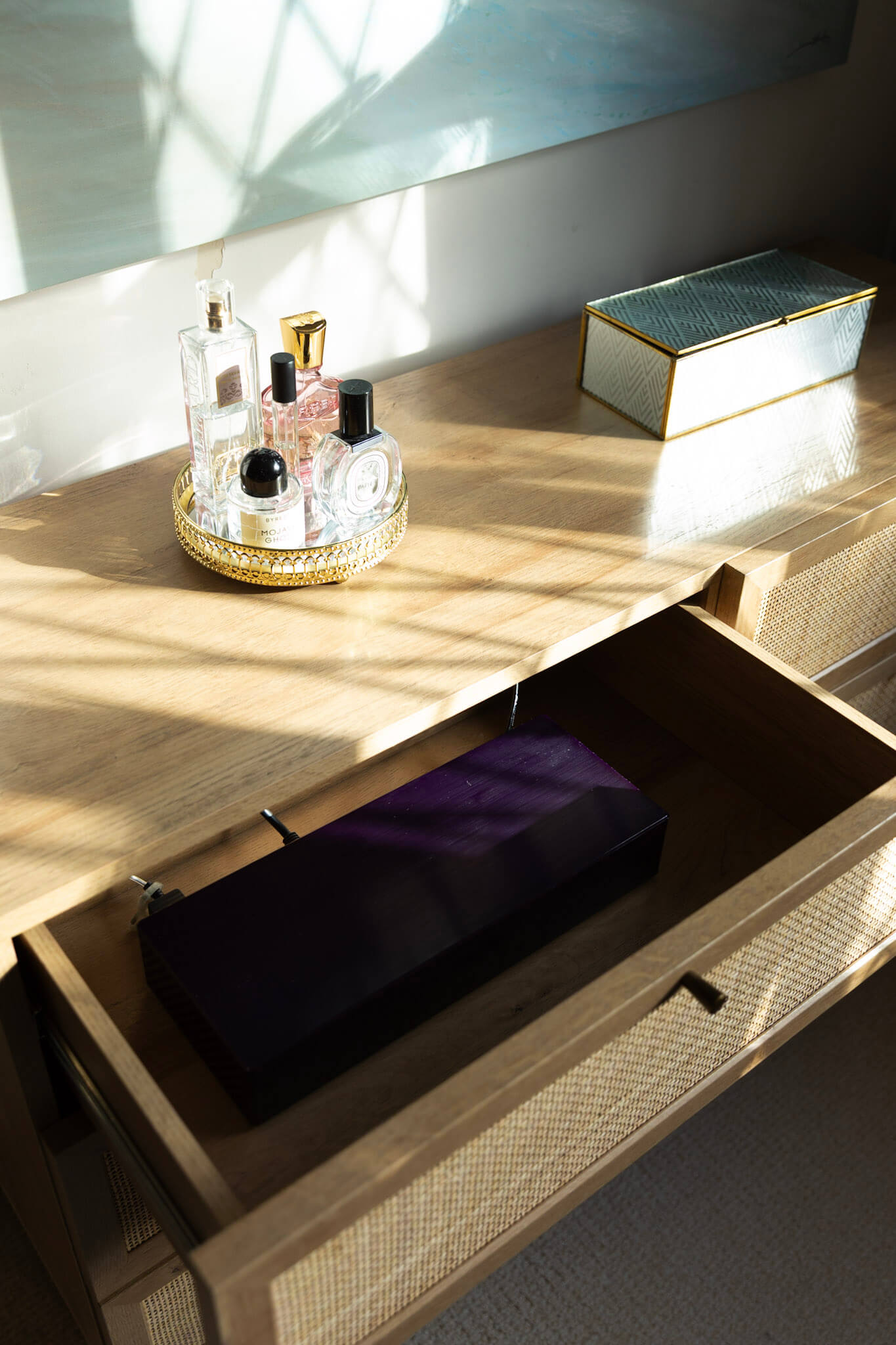 Rattan chest hiding Samsung Frame TV boxes