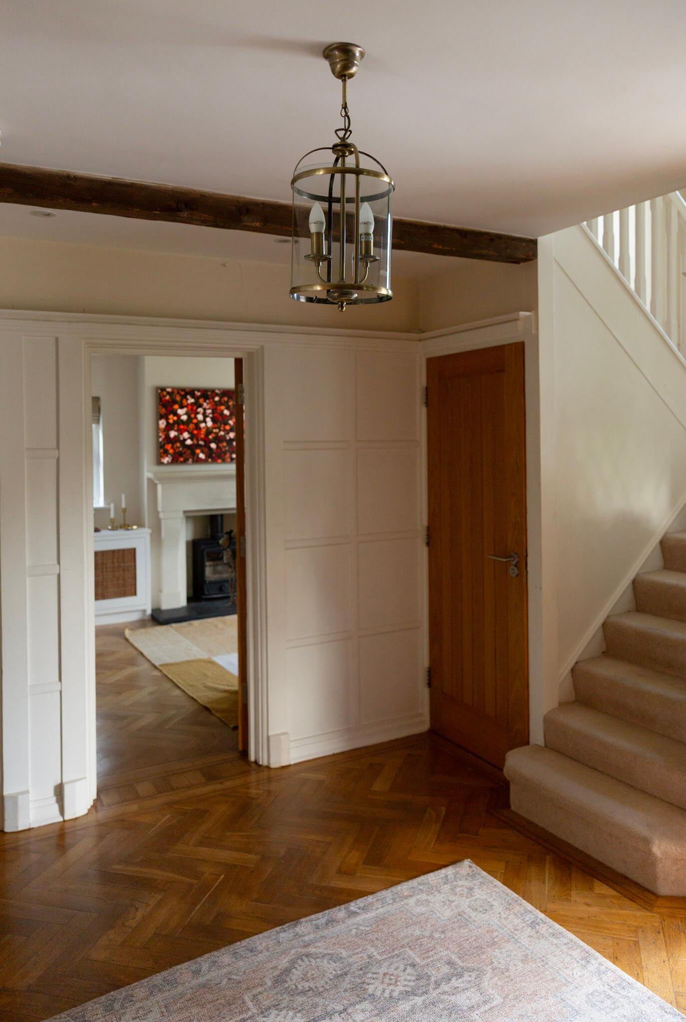Original parquet flooring and wooden beams in the hallway of a 1920s period home.