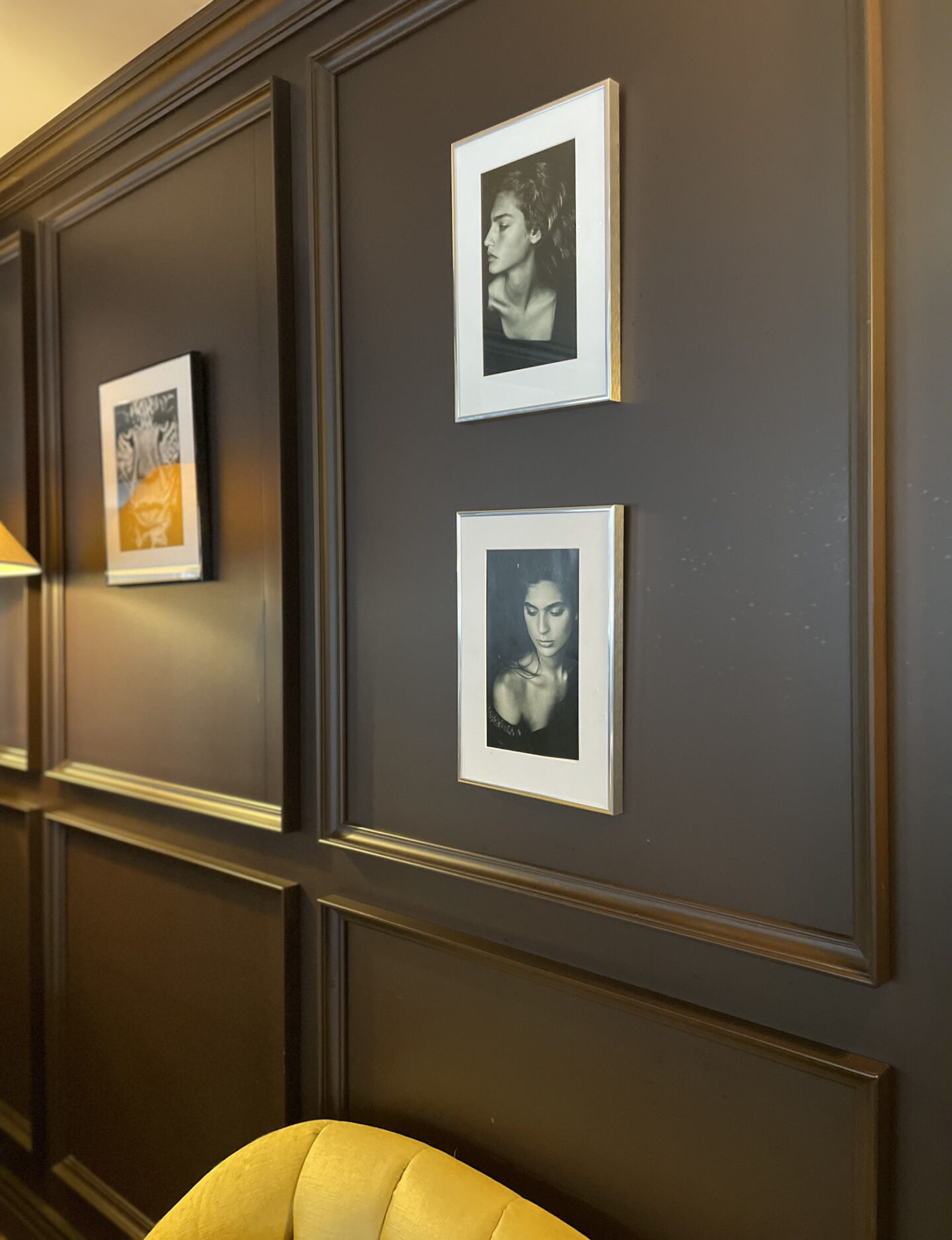 Black and white photography art displayed against dark panelled walls at Hotel Haven Helsinki