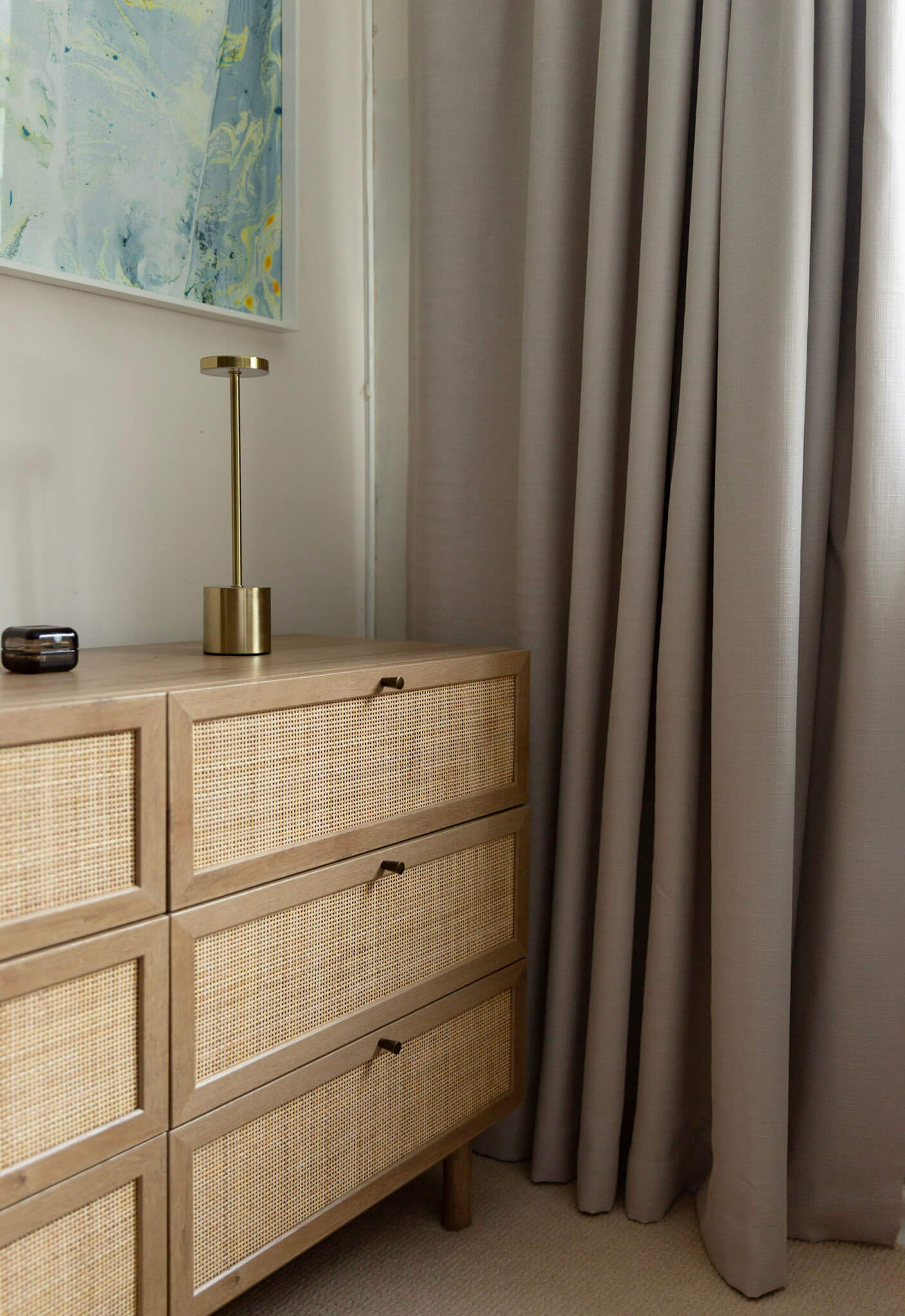 Oak rattan chest front showing the texture and colour against light grey curtains.